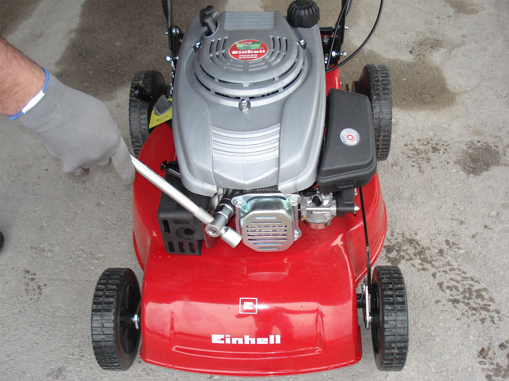 Attaching the spark plug of a lawnmower