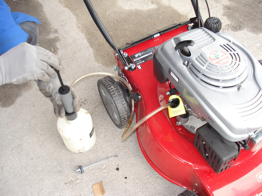Changing the oil on a lawnmower