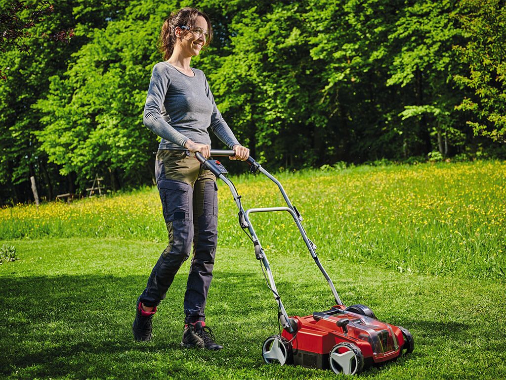 a woman scarifies the lawn