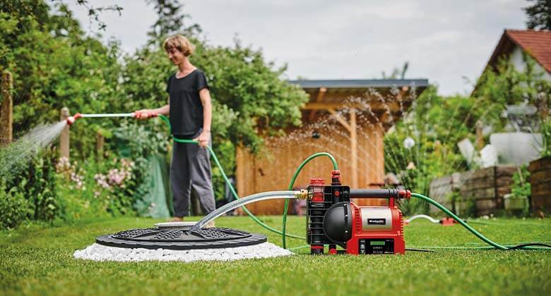 woman with a garden water pump